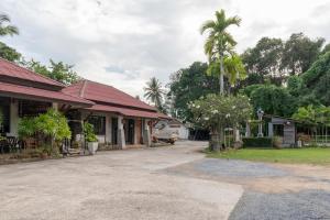 a house with a palm tree in the driveway at OYO 1046 Noppharat Resort in Ao Nang Beach