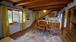 uma cozinha com mesa e cadeiras num quarto em vallemaira house casa SAN SEBASTIANO gruppi 5 - 18 persone em San Damiano Macra