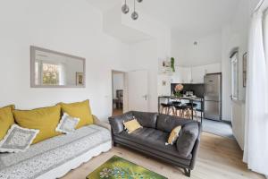 a living room with a couch and a kitchen at Chic apart terrace garden parking in Asnières-sur-Seine