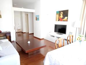 a living room with a couch and a tv at La casa dei fiori in Florence