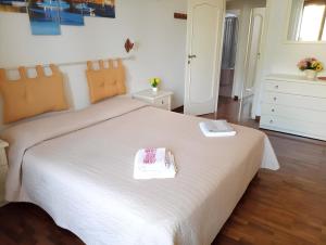 a bedroom with a white bed with two towels on it at La casa dei fiori in Florence
