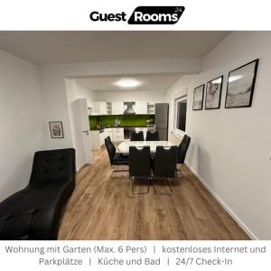 a living room with a dining table and chairs at Wohnung mit Garten EG - GuestRooms24 - Marl in Marl