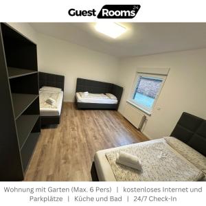 a room with two beds and a window at Wohnung mit Garten EG - GuestRooms24 - Marl in Marl