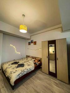 a bedroom with a bed and a door to a hallway at Cazare Iasi Palas Apartment in Iaşi