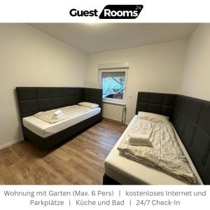 a bedroom with two beds and avertisement at Wohnung mit Garten EG - GuestRooms24 - Marl in Marl