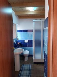 uma casa de banho com um WC, um lavatório e um chuveiro em B&B La Pietra em Arpino