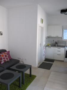 a living room with a couch and a kitchen at Apartment Annika in Tivat