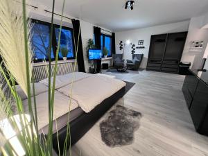 a bedroom with a bed and a living room at Rü-Premium Apartments in Essen