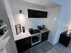 a kitchen with a black and white counter top at Rü-Premium Apartments in Essen