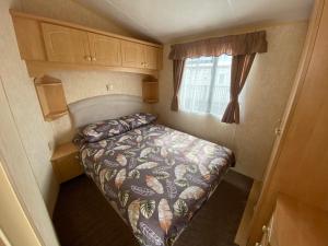 a small bedroom with a bed in an rv at The Grange - Ingoldmells - Fantasy Island in Ingoldmells