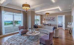 a living room with a couch and a table at Rixos Premium Tekirova - The Land of Legends Access in Tekirova