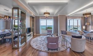 a living room with a couch and a table at Rixos Premium Tekirova - The Land of Legends Access in Tekirova
