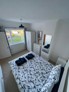 a bedroom with a bed and a large window at Family friendly home Saltburn with Seaview in Skelton
