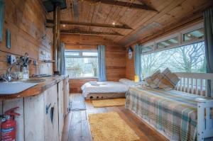 a cabin with a kitchen and a living room at The Hygge Hut - 1 Bed - Freshwest Beach Retreat in Pembroke