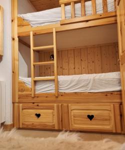 a wooden bunk bed with two drawers at Le 1954 La Rosière in Montvalezan