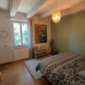a bedroom with a bed and a window at Le Mas du Coquelicot in Dions +36 photos