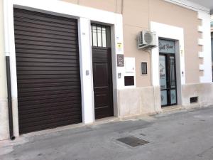two garage doors on the side of a building at Sweet Room Affittacamere in San Severo +25 photos