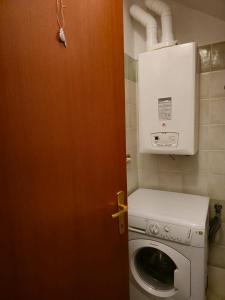 an open door to a laundry room with a washing machine at ANTICA NEVIERA HOUSE in Castel di Sangro