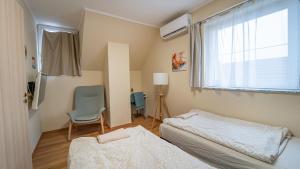 Posteľ alebo postele v izbe v ubytovaní Palmy Apartmanhouse Maglód