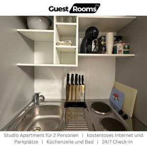a kitchen with a sink and a counter top at Studio Apartment - GuestRooms24 - Marl in Marl