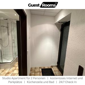 a bathroom with a walk in shower and a glass door at Studio Apartment - GuestRooms24 - Marl in Marl