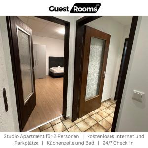 a hallway with two doors and a room with a bed at Studio Apartment - GuestRooms24 - Marl in Marl