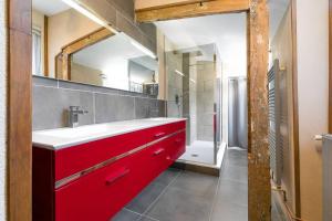 a bathroom with a red sink and a shower at L'Escale in Dijon +8 photos