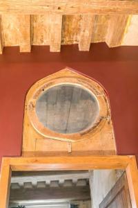 a wooden door with a window on a red wall at L'Escale in Dijon