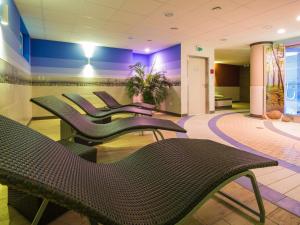 a waiting room with black chairs and purple walls at Residenz Seestern, Boltenhagen in Boltenhagen