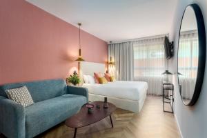 a hotel room with a bed and a couch at Tribu Malasaña in Madrid