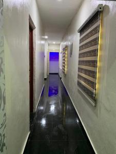 a long hallway with a blue light in a building at Arena Guest House and Lounge in Ikeja