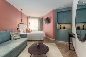a living room with a couch and a bed at Tribu Malasaña in Madrid