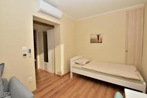 Posteľ alebo postele v izbe v ubytovaní Palmy Apartmanhouse Maglód