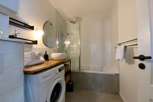 bagno con lavatrice e doccia di Le Lovely - Appartement avec clim et piscine ! a Le Crès Altre 4 foto