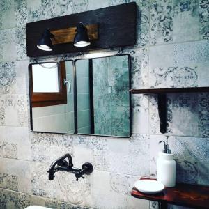 a bathroom with a mirror and a sink at Location Casa Di Lesia à Sotta / Porto-Vecchio in Sotta