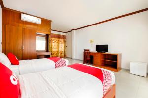 Säng eller sängar i ett rum på OYO 732 Juthamas Hotel