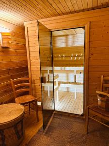 a room with a sauna with a table and a chair at Apartament Forest in Mysłakowice