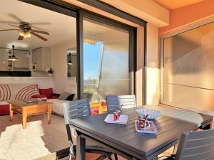 a dining table and chairs in a living room at Appartement 2 pièces, climatisé, 100m plage, parking, Le Lavandou - FR-1-251-218 in Le Lavandou