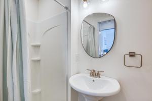 a white bathroom with a sink and a mirror at Spacious Wildwood Condo Walk to Beach! in Wildwood +21 photos