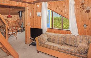 a living room with a couch and a television at Two-Bedroom Holiday Home In Hemmet in Hemmet