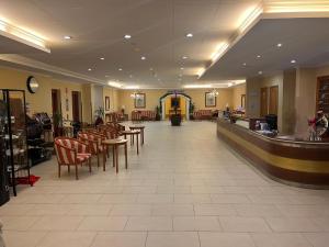 a waiting room with tables and chairs in a restaurant at Hotel Marysol Apt Los Cristianos Atlantic View in Los Cristianos +29 photos
