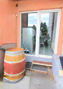 a barrel sitting outside of a house with a window at Ferienwohnung Best Apartments Leverkusen 1 in Leverkusen