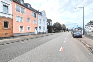 an empty street with cars parked on the side of the road at Ferienwohnung Best Apartments Leverkusen 1 in Leverkusen