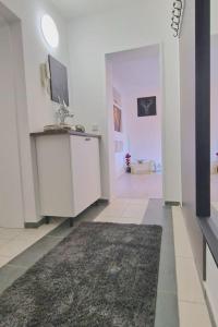 a white room with a rug on the floor at Ferienwohnung Best Apartments Leverkusen 1 in Leverkusen