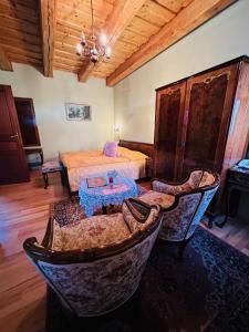 a bedroom with a bed and a table and chairs at Öreg Prés Butikhotel in Mór