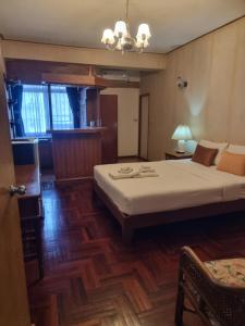 a bedroom with a bed and a table and a chair at 12PM Bangkok in Bang Kapi