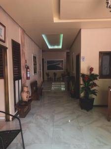 a hallway of a building with a plant and stairs at Pousada Cabocla - 300 metros da Ilha do Amor in Alter do Chao