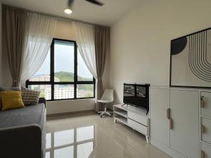 a living room with a couch and a television at Homely Haven in Kajang 21-09 in Kajang