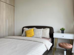 a bedroom with a bed and a table and a stool at Homely Haven in Kajang 21-09 in Kajang +29 photos