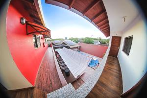 a hammock on the balcony of a house at Pousada Bonito Cama e Café in Bonito